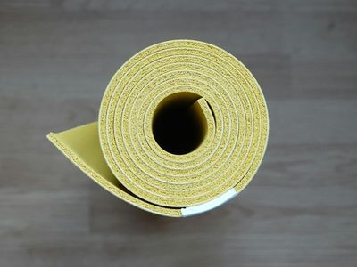 Close up of a rolled green yoga mat